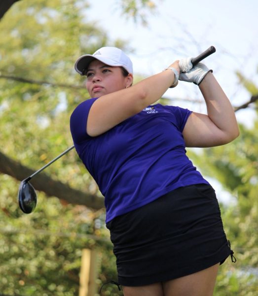 Carina Hernandez watching her drive just after teeing off 